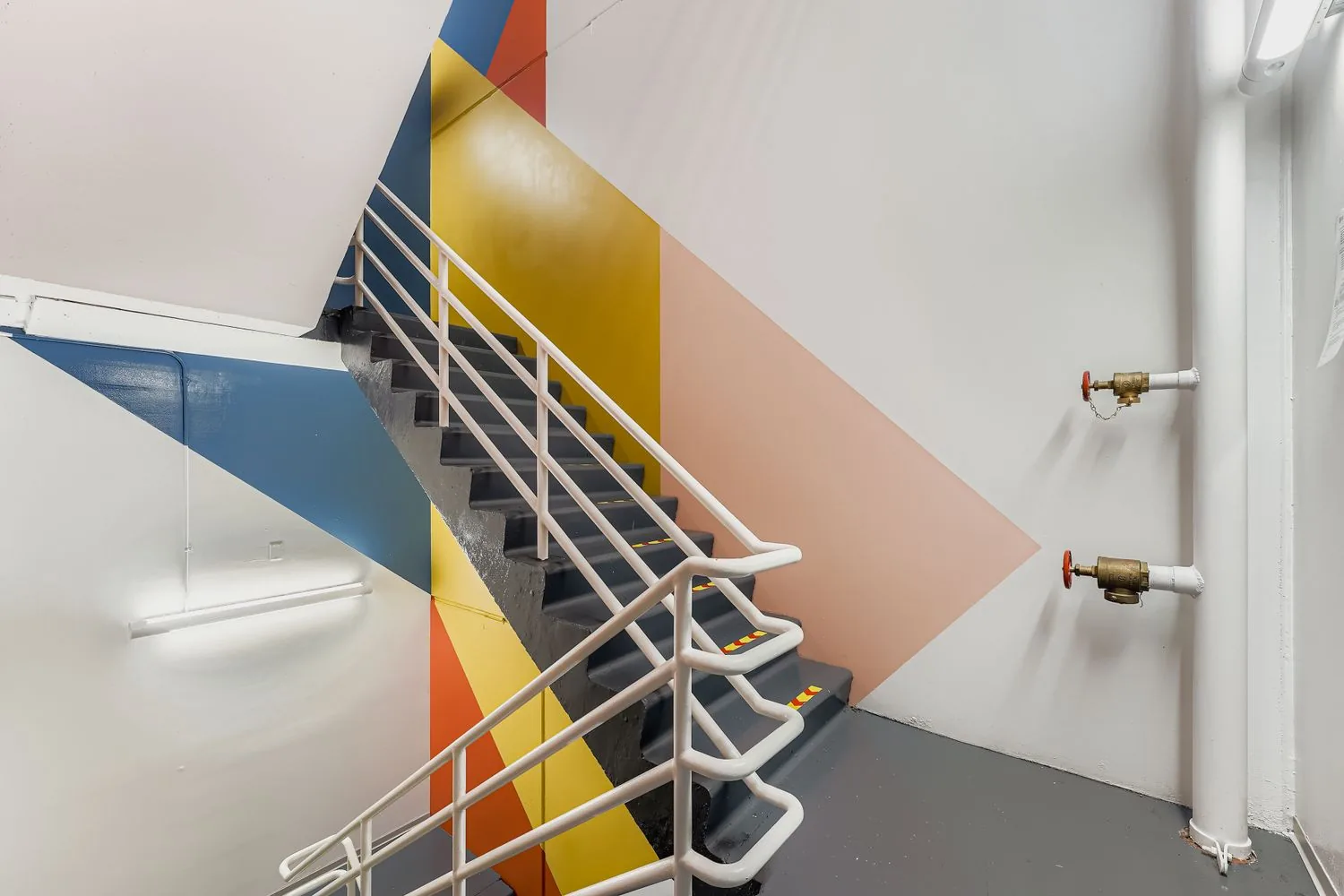 Colorful stairwell mural near 2850 Youngfield